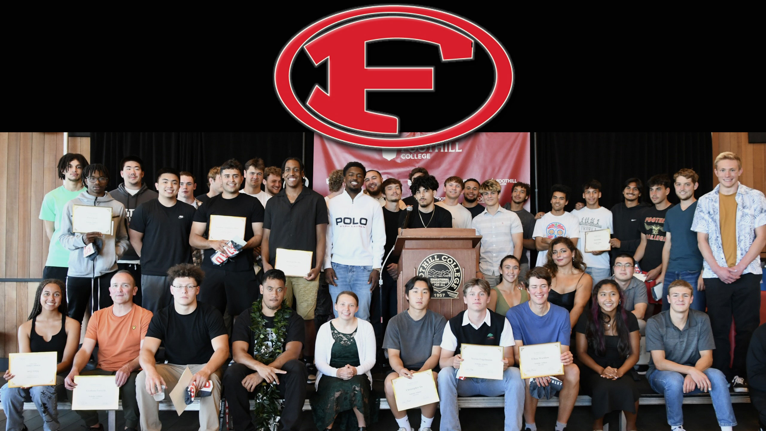 group of athletes on a stage. F logo in red at the top of the screen.